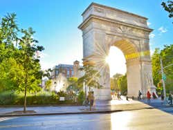 A view of Washington Square Arch with the sun shining through